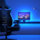 One of Vertagear's RGB chairs sitting ominously in front of a desk.